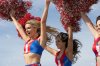 8837345-cheerleaders-running-holding-pom-poms-in-air-Stock-Photo.jpg