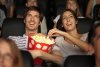 297670-1600x1068-couple-eating-movie-theater-popcorn.jpg
